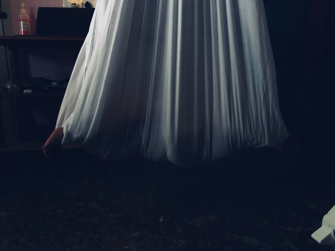 woman in white dress standing on black floor