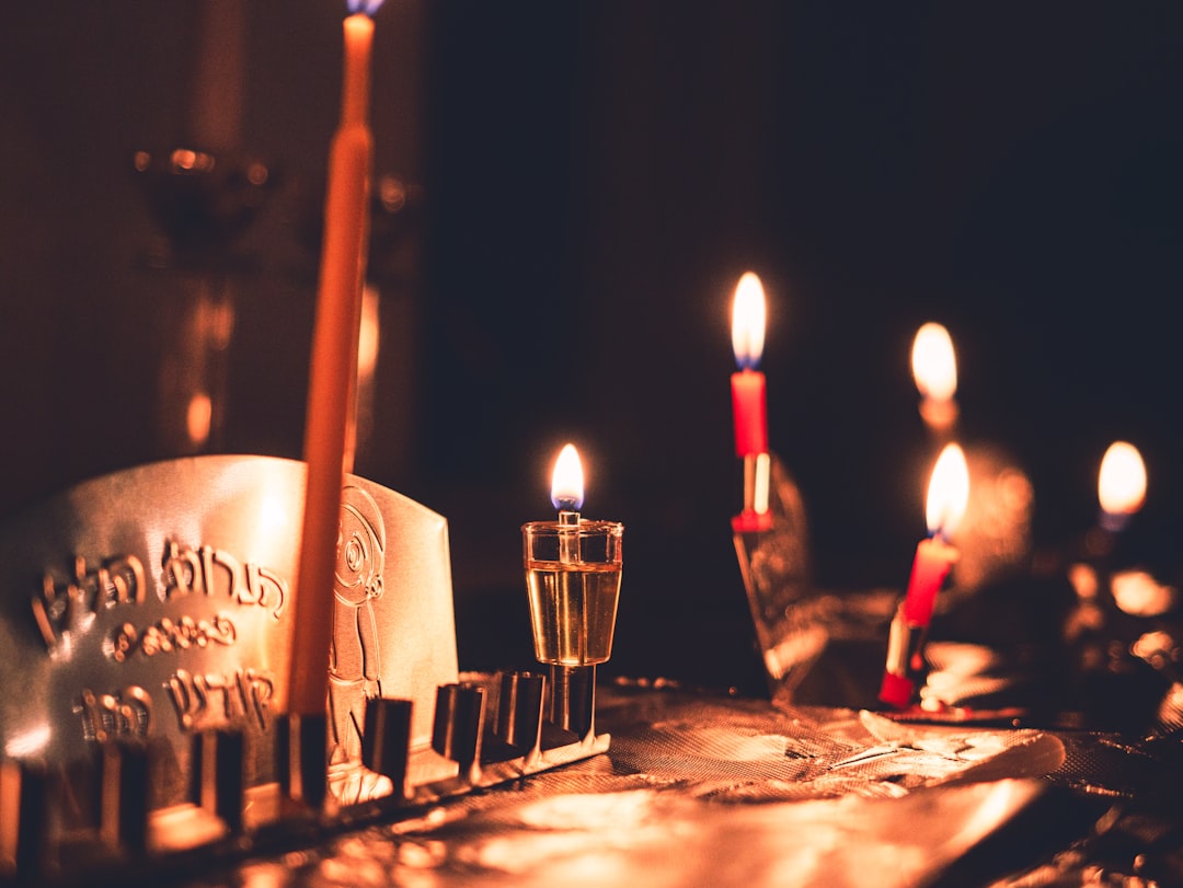 A table topped with candles and a cake covered in frosting